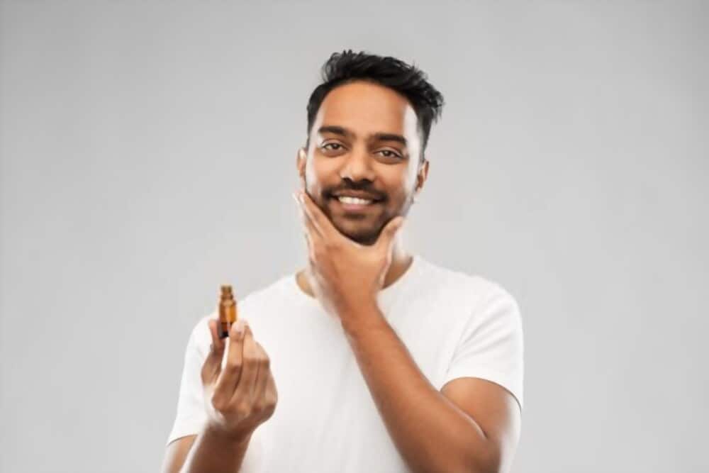 man applying oil for razor bumps